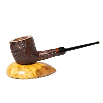 Wooden smoking pipe on a wooden stand with a white background