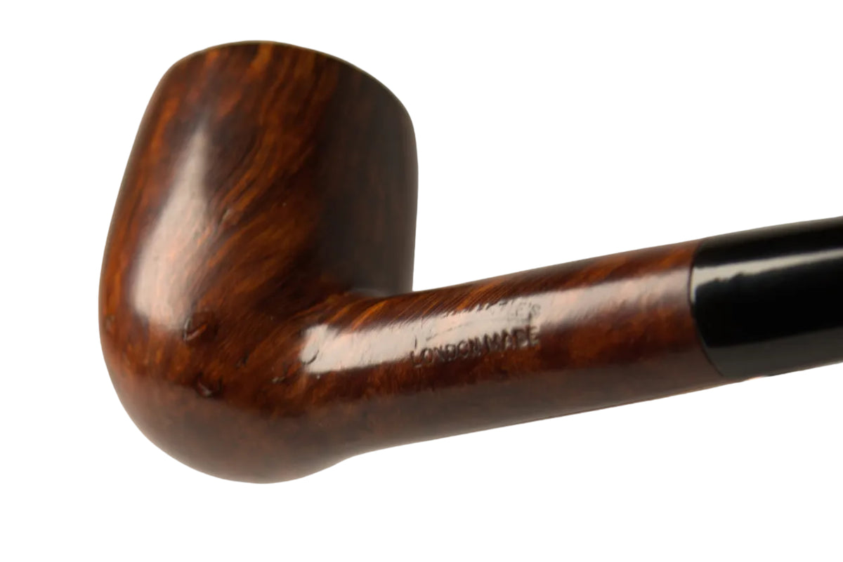 A close-up studio shot of a smoking pipe with a polished dark brown wooden bowl and a black stem, resting on a matching wooden stand against a neutral gray background.