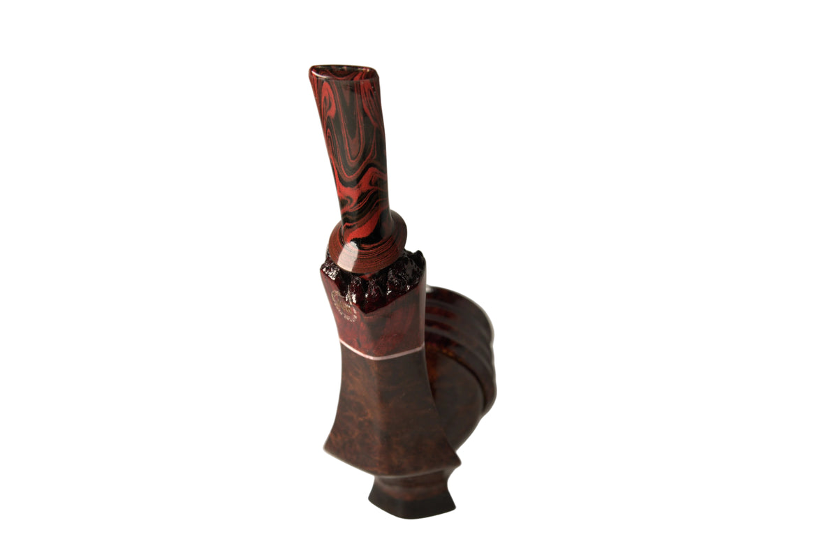 A dark reddish-brown ceramic vase with a glossy marbled red and black pattern, standing on a small black base against a neutral light gray background.