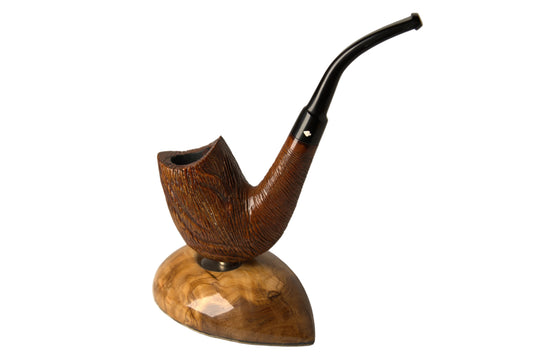 A handcrafted smoking pipe with a richly textured brown wooden bowl and a curved black stem, displayed on a polished wooden stand against a neutral gray background.