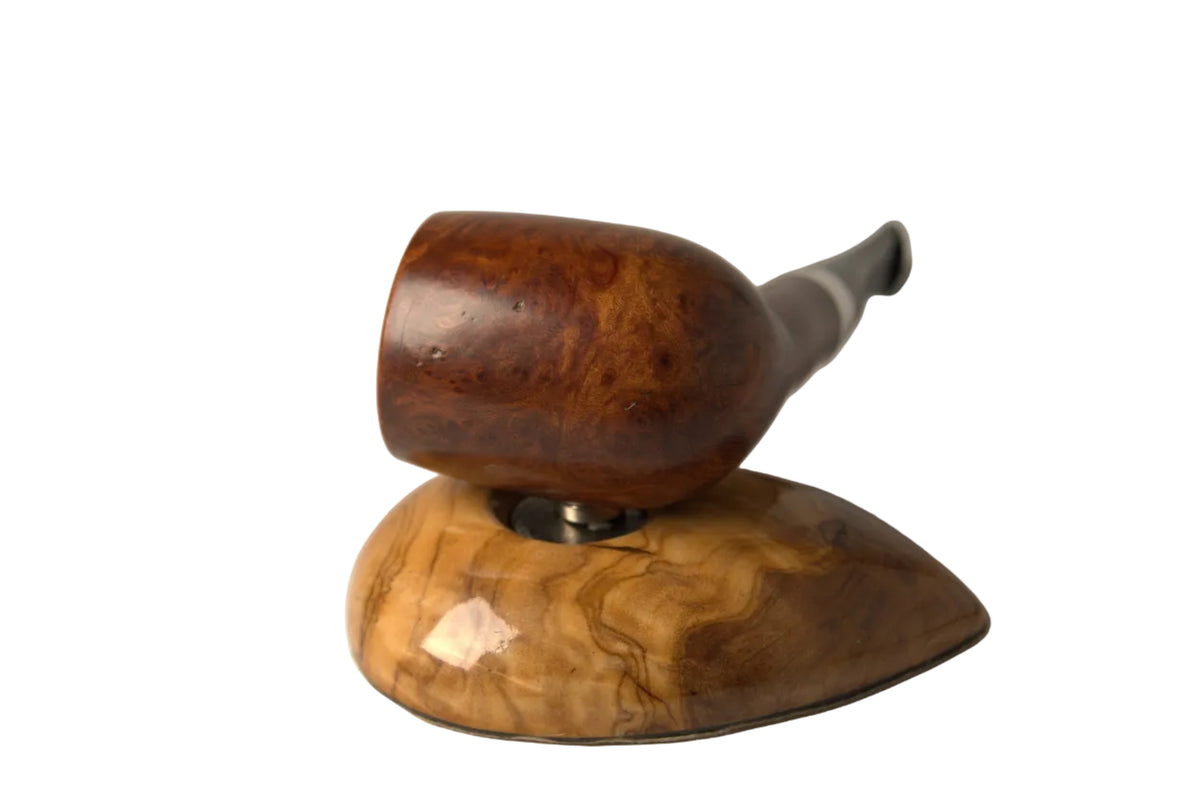 A smoking pipe with a polished dark brown wooden bowl and a silver-toned stem, resting on a matching carved wooden stand against a neutral gray background.