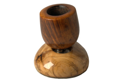 A small wooden smoking pipe with a polished dark brown top section and a lighter tan wood base, photographed on a plain light gray studio background.