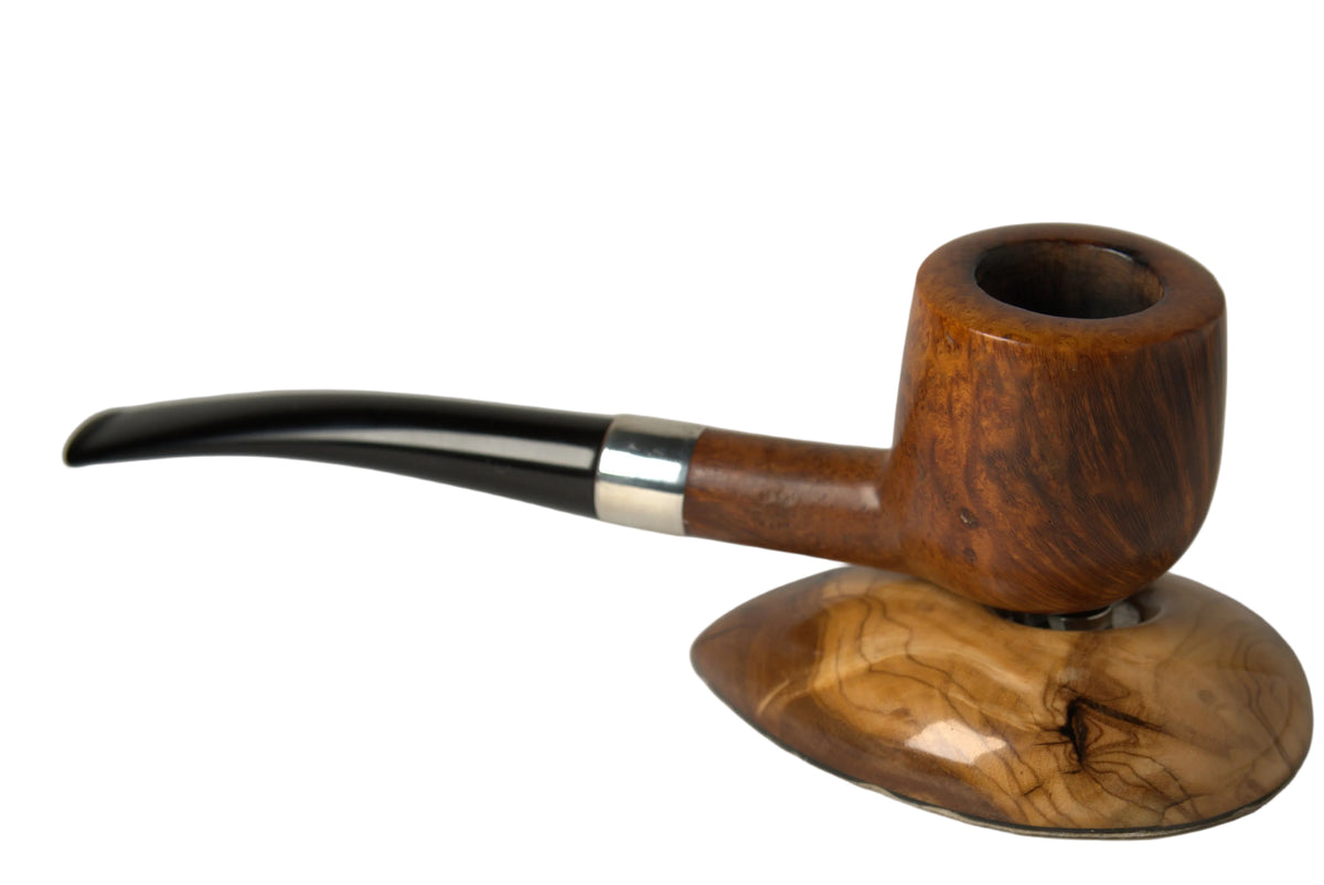 A wooden smoking pipe with a dark brown stem and silver band, resting on a matching carved wooden stand against a neutral gray background.