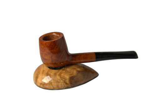 A smoking pipe with a polished brown wood bowl and a dark black stem, displayed on a matching carved wooden stand against a neutral gray background.