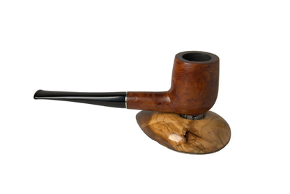 A handcrafted smoking pipe with a rich brown wood body and a glossy black stem, displayed on a polished natural wood stand against a neutral gray background.