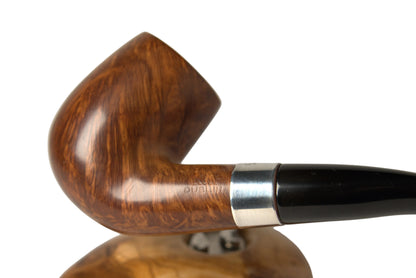 A close-up of a smoking pipe with a rich brown wood bowl and a black stem, resting on a matching wooden stand against a neutral light gray background. A finger is visible holding the stem on the right side.