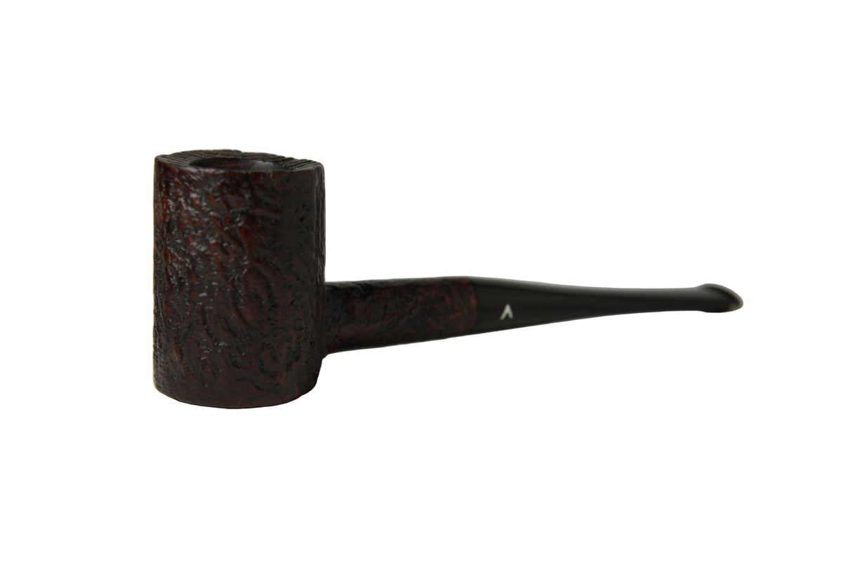 A dark brown carved smoking pipe with a textured, patterned bowl and a slender black stem, photographed on a neutral light gray background.
