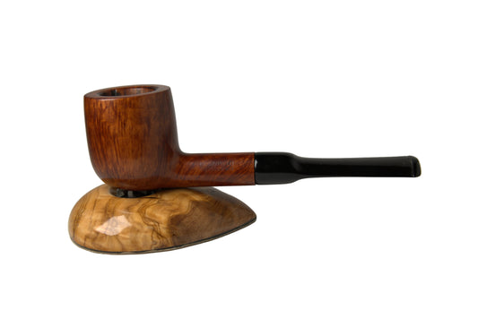 A smoking pipe with a rich brown wood bowl and a black stem, resting on a matching polished wood display stand against a neutral gray background.
