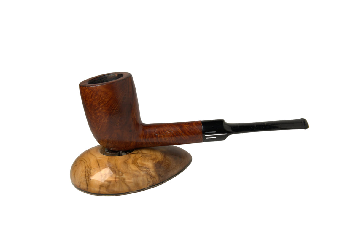 A smoking pipe with a rich brown wood body and a black stem, displayed on a matching polished wood stand against a neutral gray background.