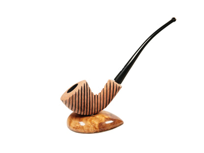 A carved smoking pipe with a curved black stem and a striped brown wooden bowl, resting on a polished matching wooden base against a plain white background.