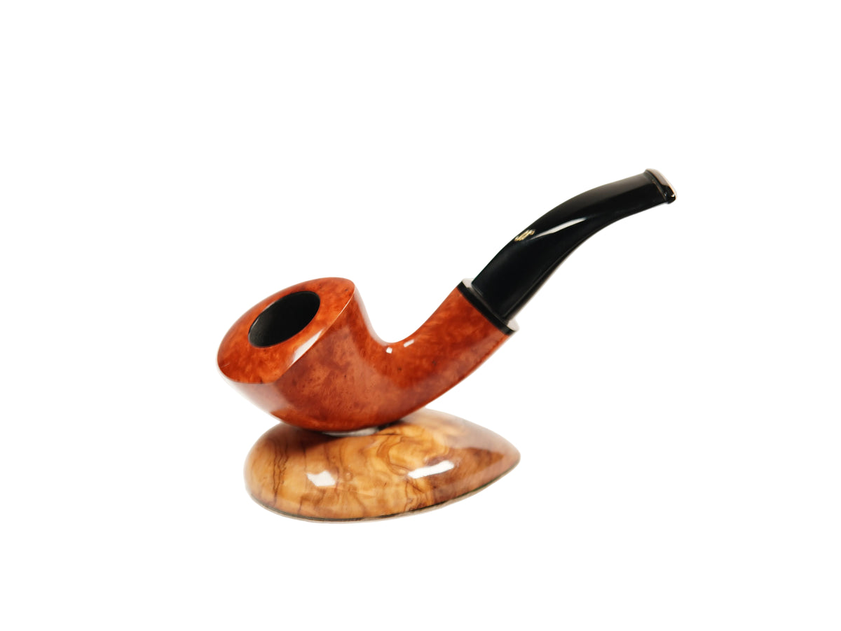 A smoking pipe with a glossy orange-brown wood bowl and a curved black stem, displayed on a matching polished wood stand against a plain white background.