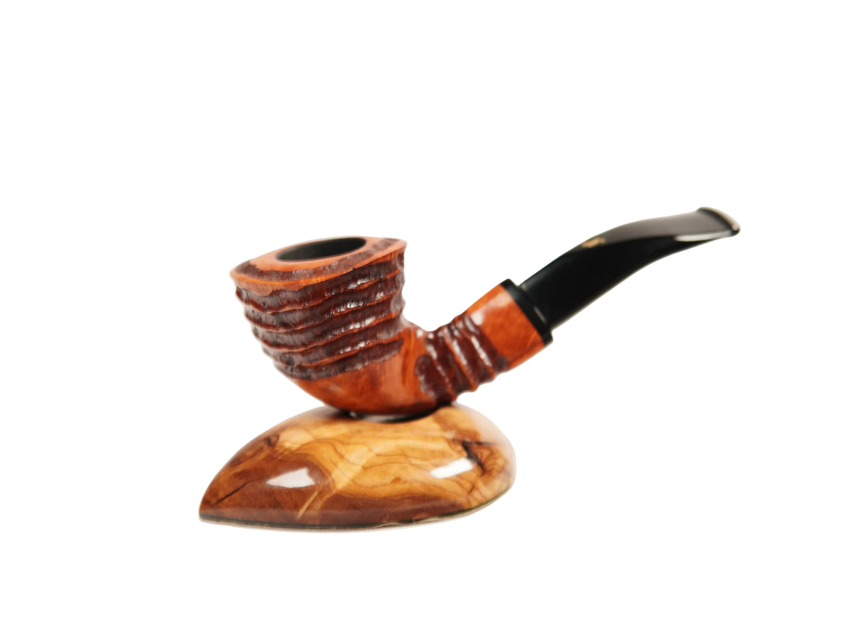A handcrafted smoking pipe with a carved brown wooden bowl and a glossy black stem, resting on a matching polished wooden display stand against a plain white background.