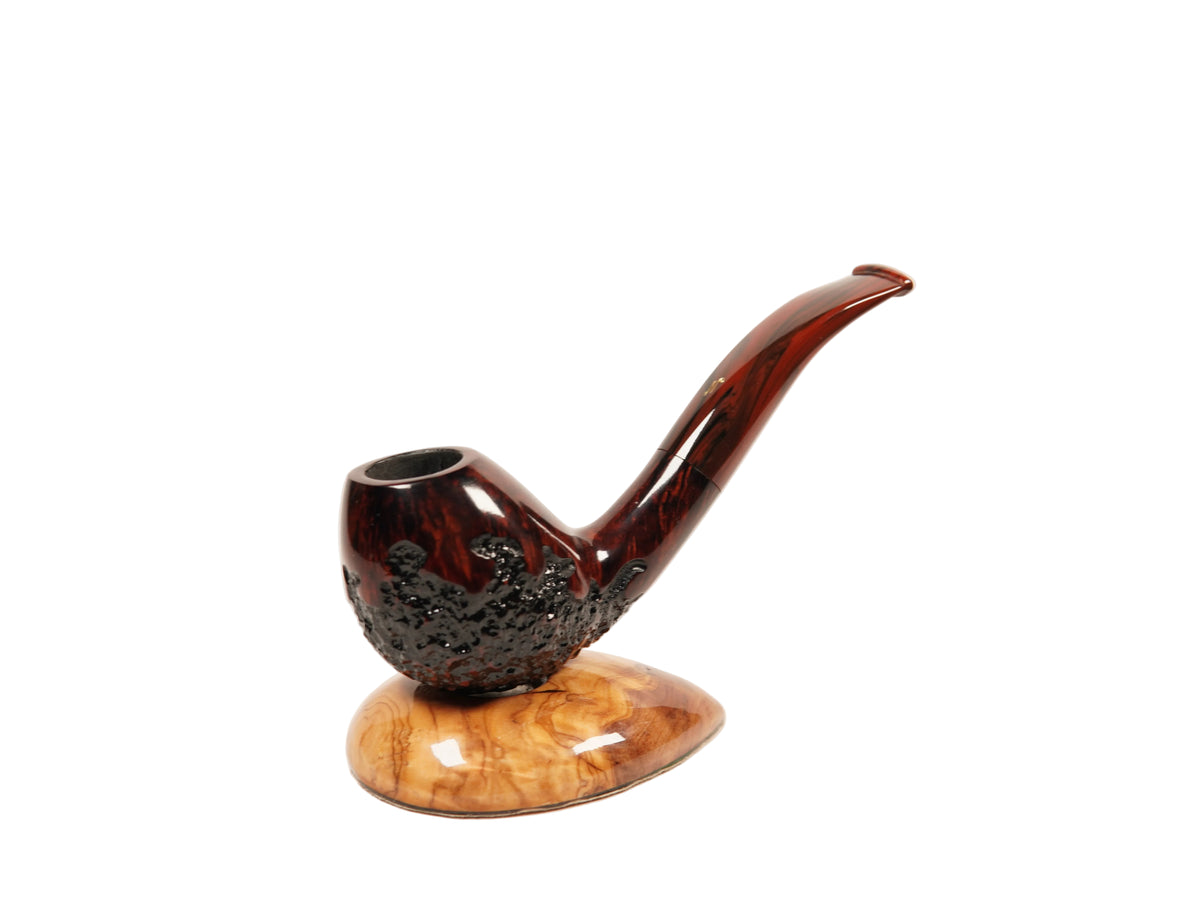 A decorative smoking pipe with a glossy dark reddish-brown body, a curved stem, and a carved textured bowl, displayed on a polished wood stand against a plain white background.