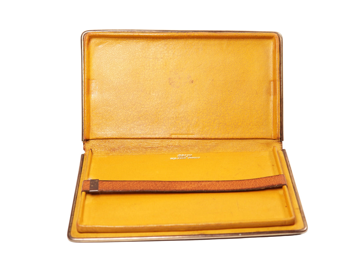 A rectangular brown leather portfolio folder or notebook cover with a silver metal edge, shown closed on a plain white background.