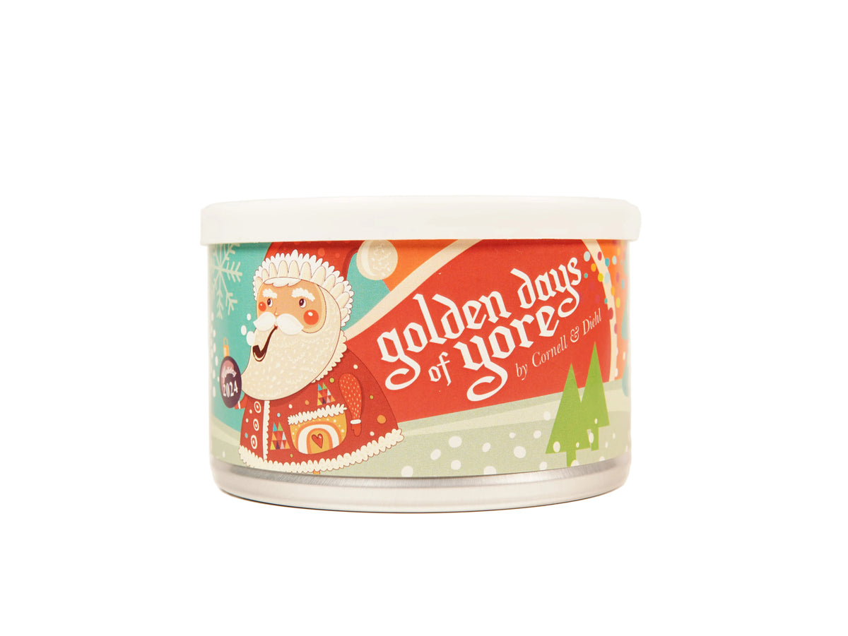 A clear plastic tub of candles with a white lid, featuring a colorful holiday label with Santa Claus and the text 'golden days of yores by Carmen & Dan'.