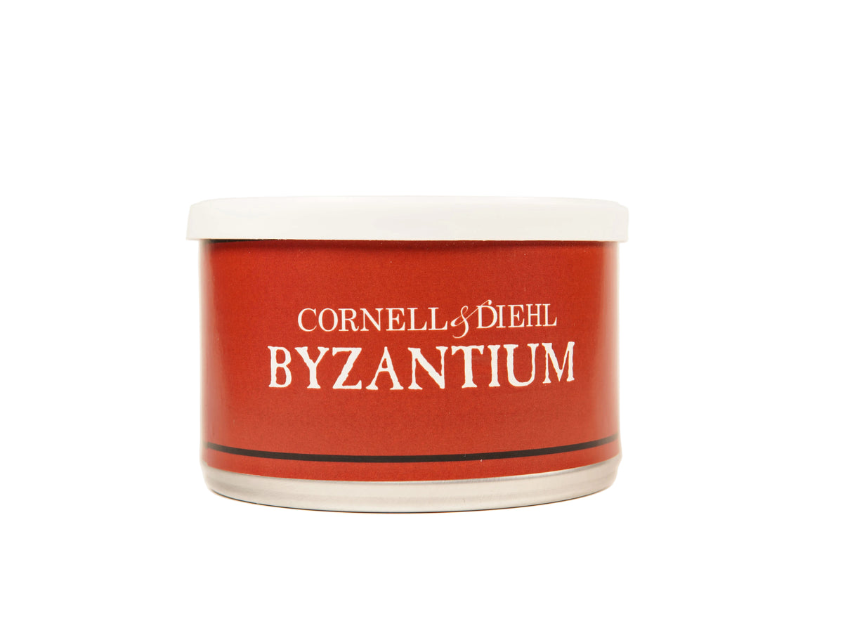 A red cylindrical jar of Cornell & Diehl Byzantium nail polish with a white lid, set against a plain off-white background.