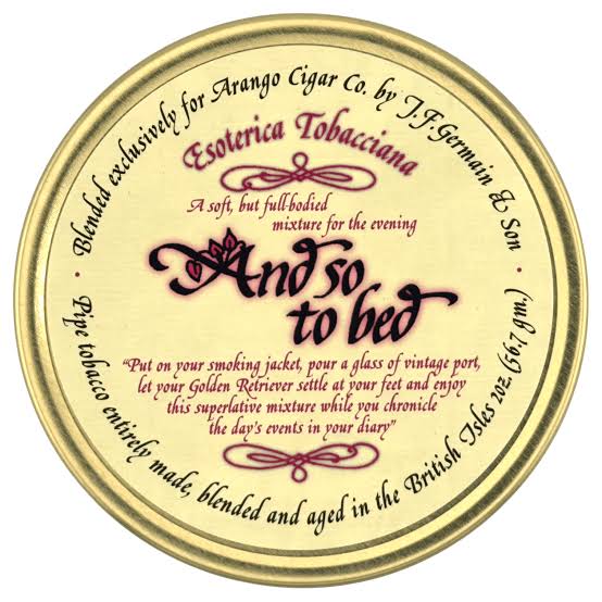 Round gold tin lid for Esoterica Tobaccana 'And so to bed' tobacco blend, featuring cream background and black and burgundy text.